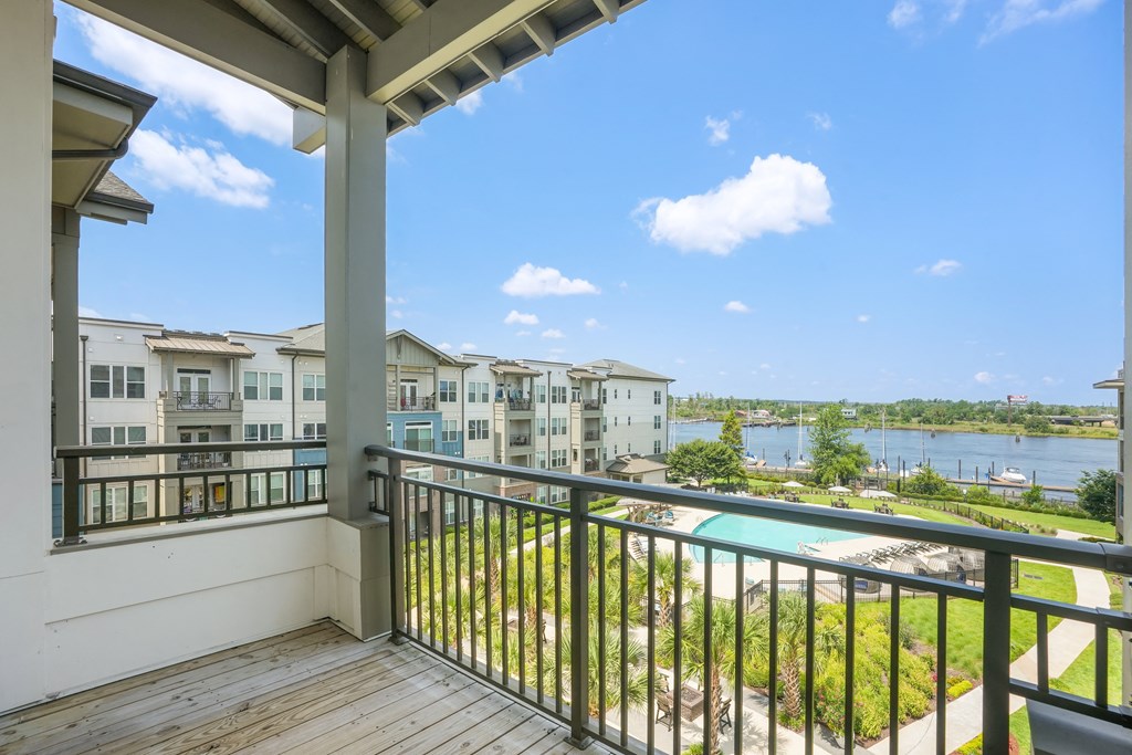 the view from the balcony of an apartment building overlooking the water