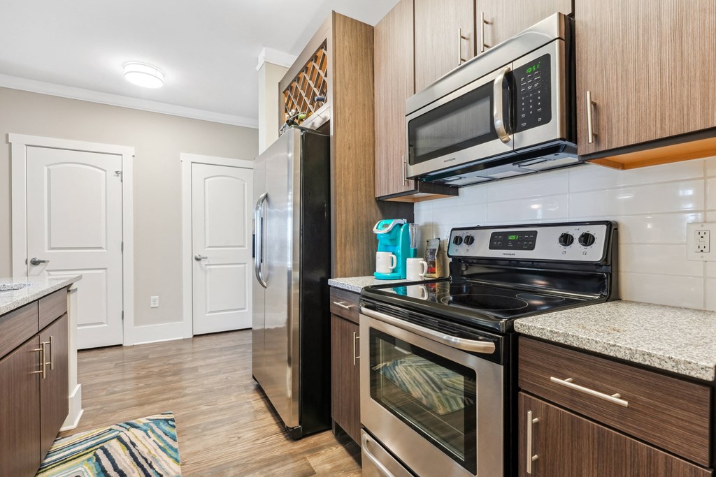 a kitchen with stainless steel appliances and wooden cabinets