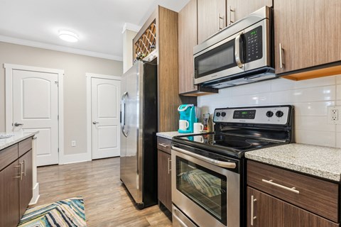 a kitchen with stainless steel appliances and wooden cabinets