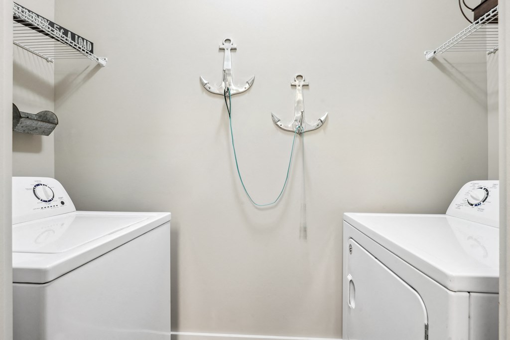 a small laundry room with a washer and dryer and a sink