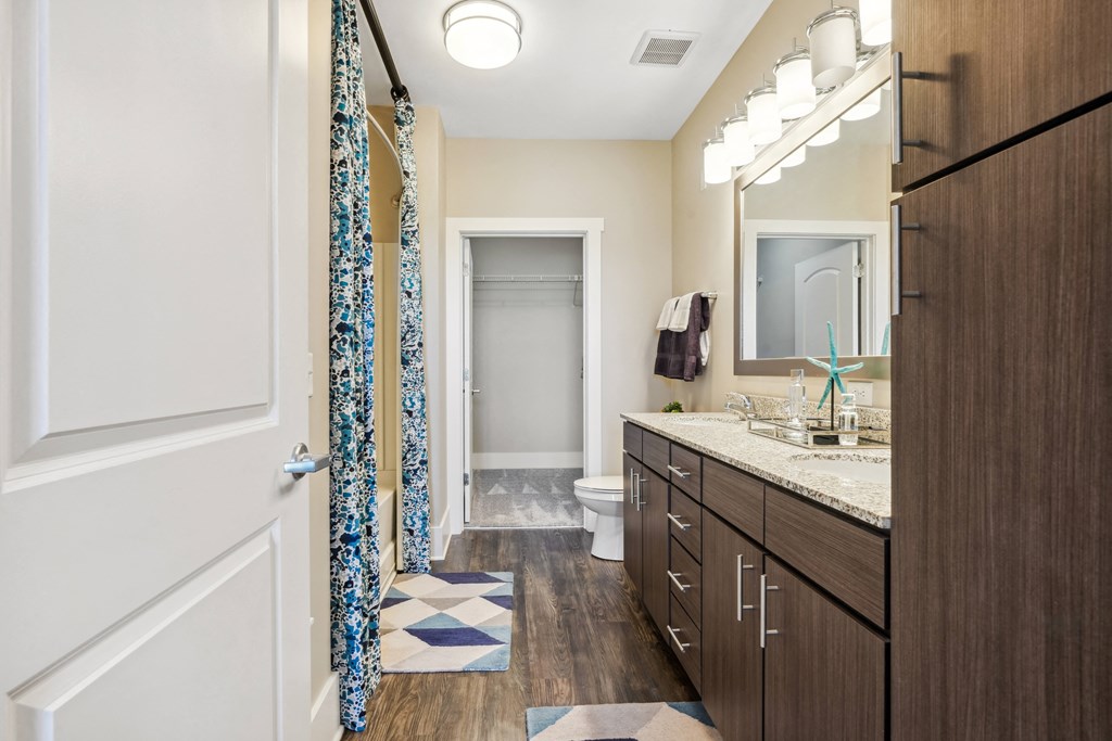 a bathroom with a shower and a sink and a mirror