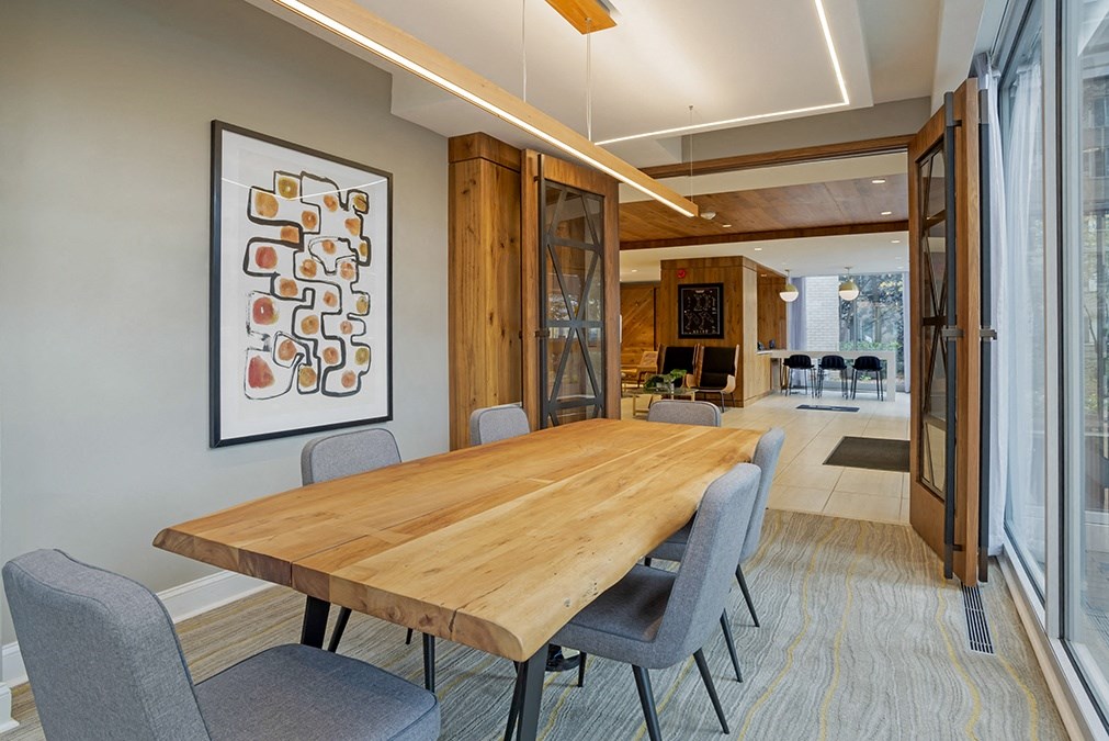 a dining room with a wooden table and chairs