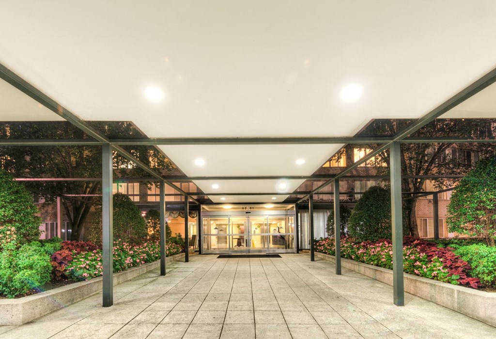 the lobby of a building with plants on both sides of it