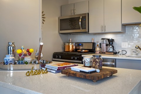 a kitchen counter with books and other items on it