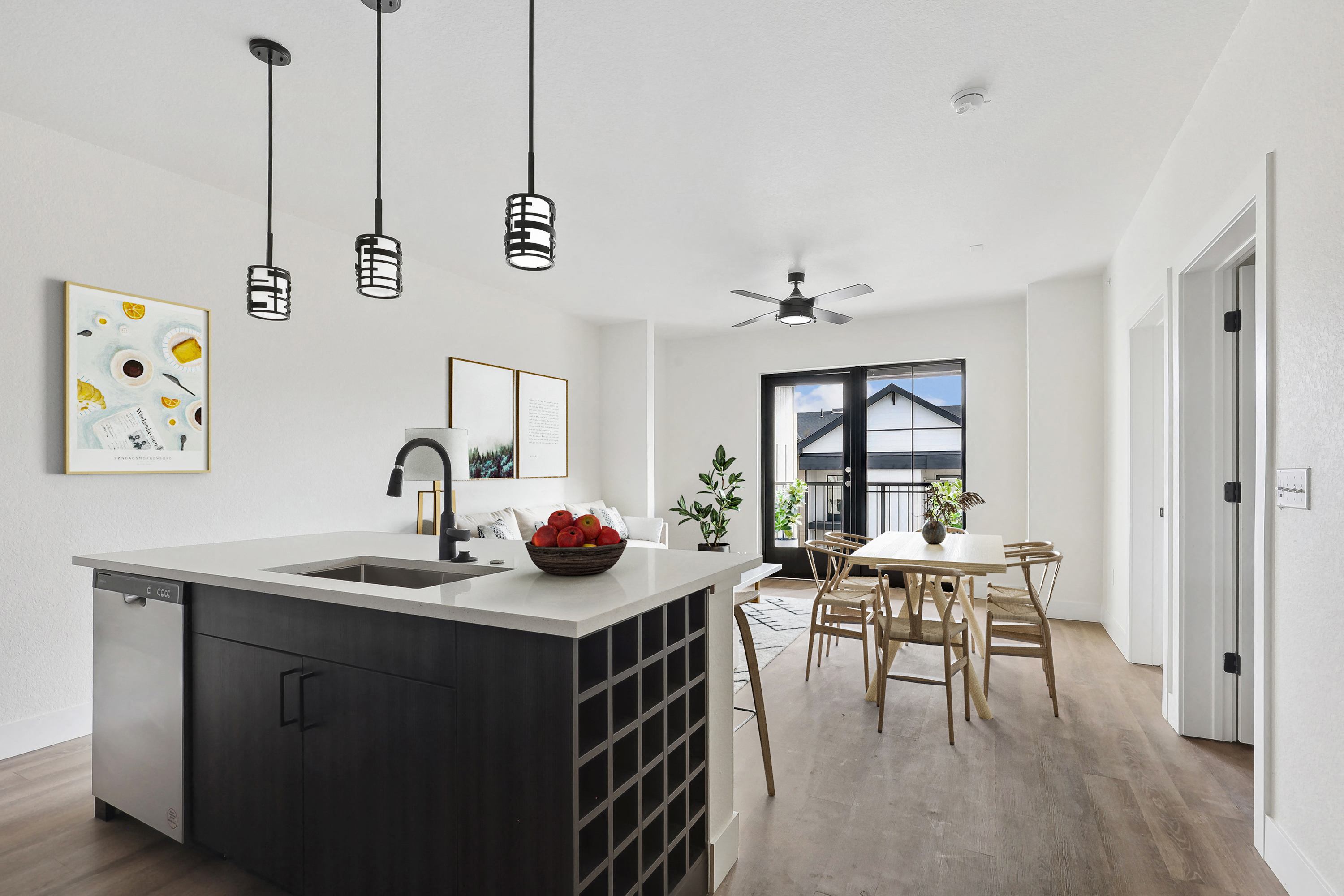 a kitchen with a large island and a dining room with a table and chairs