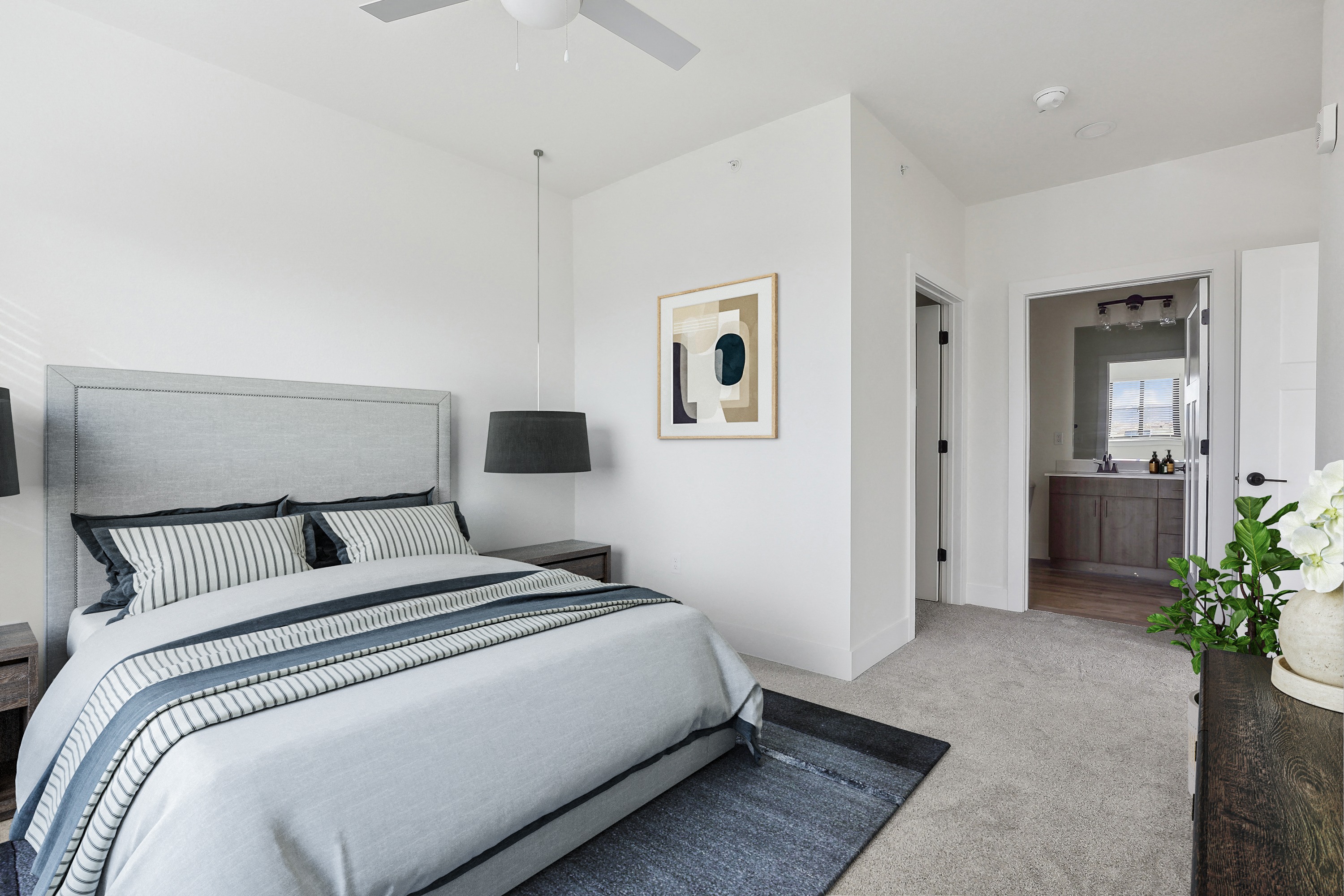 a bedroom with a bed and a ceiling fan