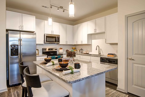 a kitchen with stainless steel appliances and granite counter tops