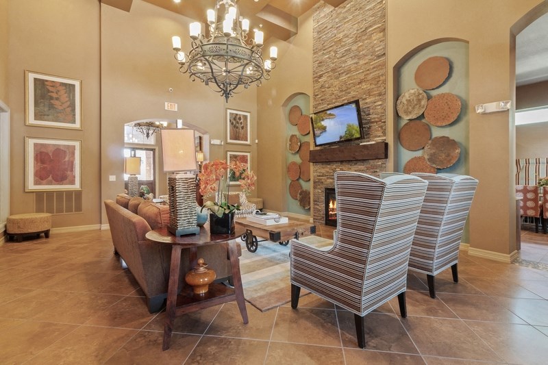 a living room with two chairs and a fireplace