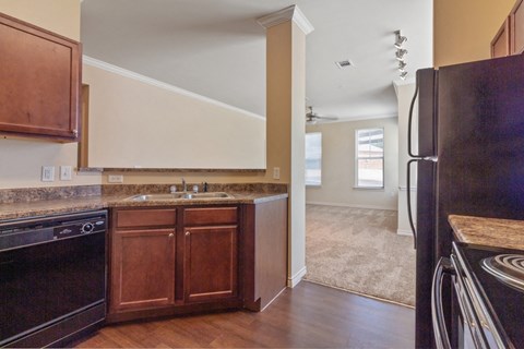 a kitchen with black appliances and wooden cabinets