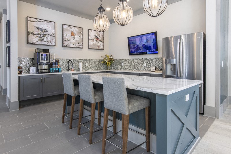 a kitchen with a marble counter top and bar stools
