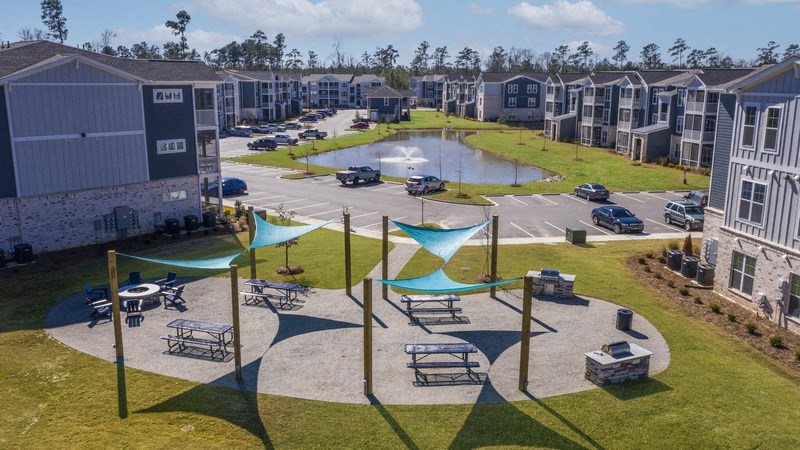 an aerial view of an apartment complex with a swimming pool