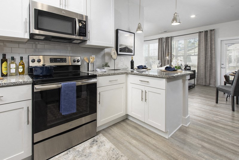 a kitchen with stainless steel appliances and white cabinets
