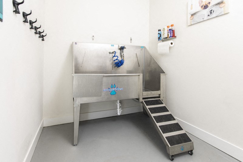 a large stainless steel sink in a room with stairs