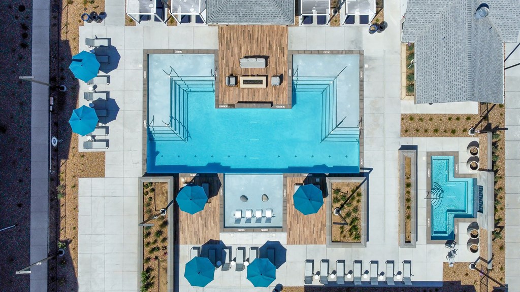 a birds eye view of the pool area of a house with a pool and patio
