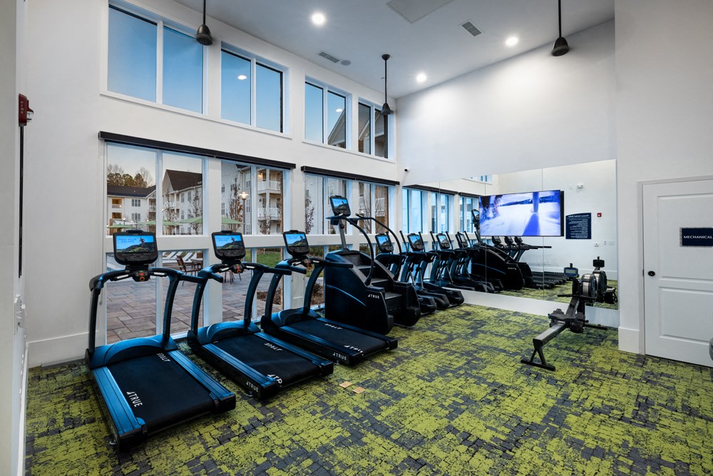 A gym with treadmills and exercise bikes.