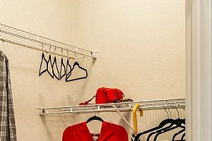 a bathroom with a red jacket hanging on the wall