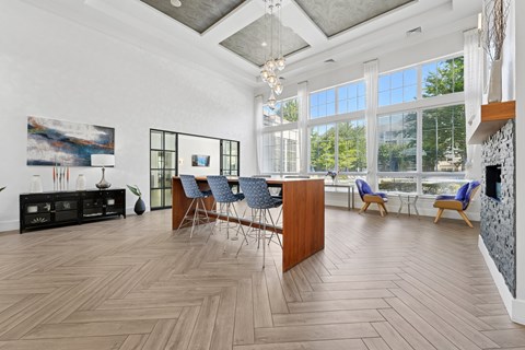 A spacious room with wooden flooring and a large window.