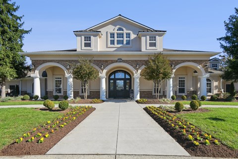 A large, well-maintained house with a front yard and landscaping.