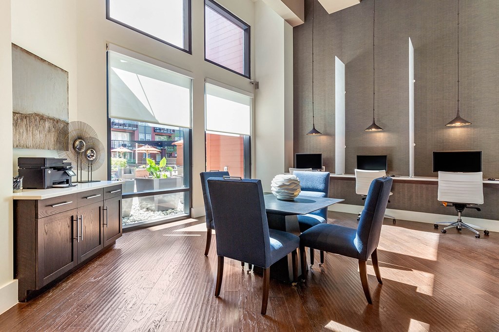 a dining room with a table and chairs and a kitchen with a large window