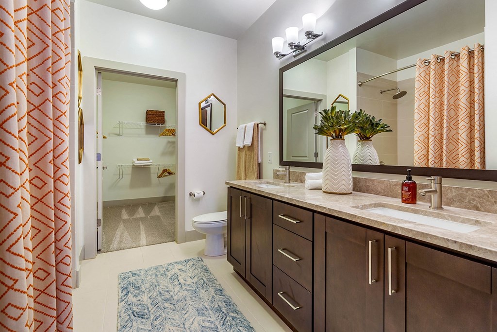 a bathroom with a sink and a toilet and a mirror