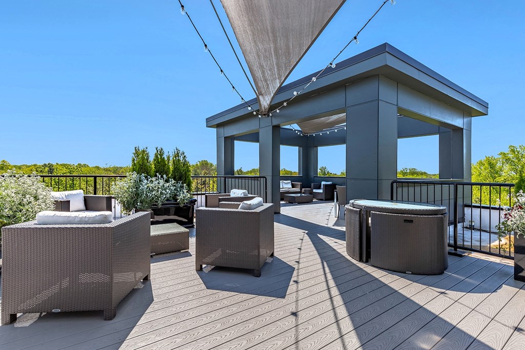 the deck has a roof terrace with tables and chairs and a pavilion