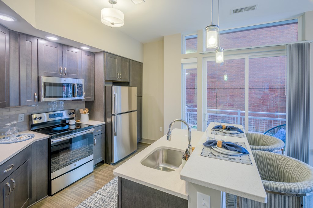 a kitchen with stainless steel appliances and a large window