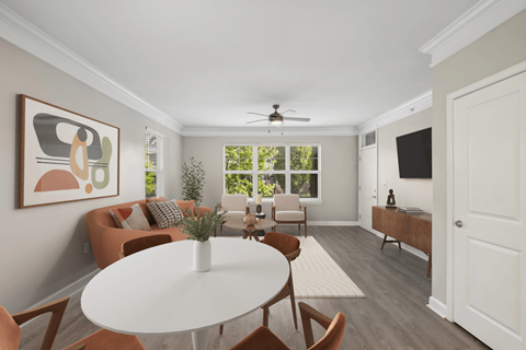 A living room with a white table and chairs.