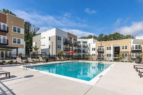 A swimming pool in front of apartment buildings.