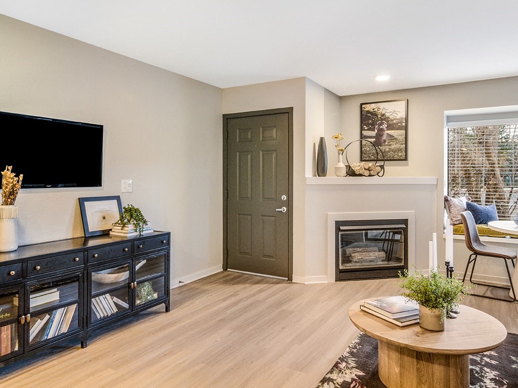 a living room with a fireplace and a tv