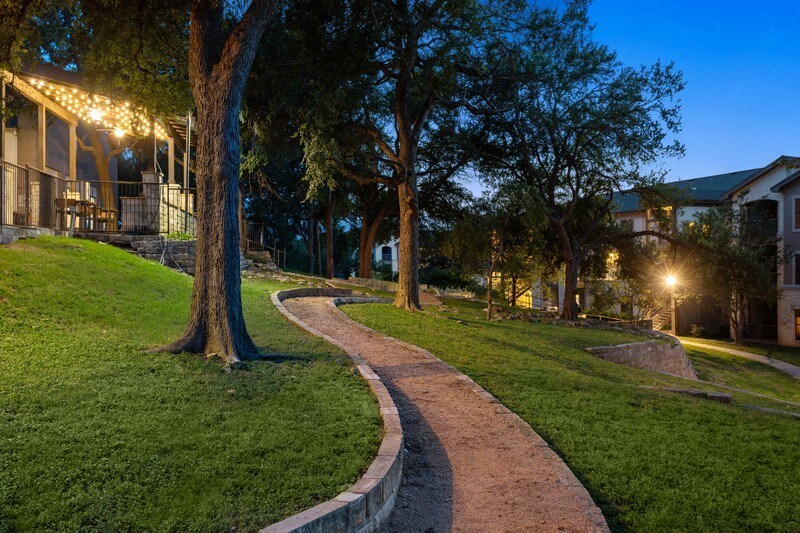 a pathway through a park at night