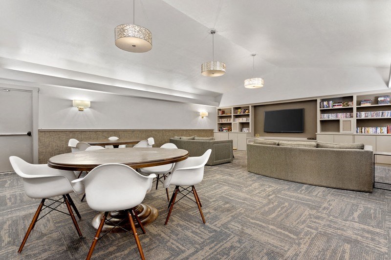 a room with a table and chairs and a television
