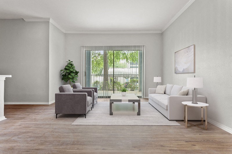 a living room with white walls and a large window