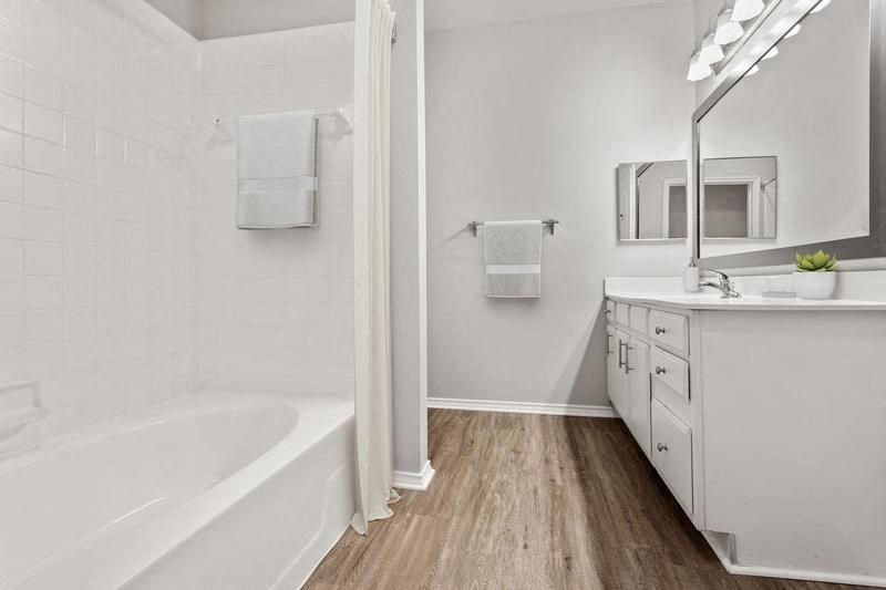 a bathroom with a bathtub and a sink