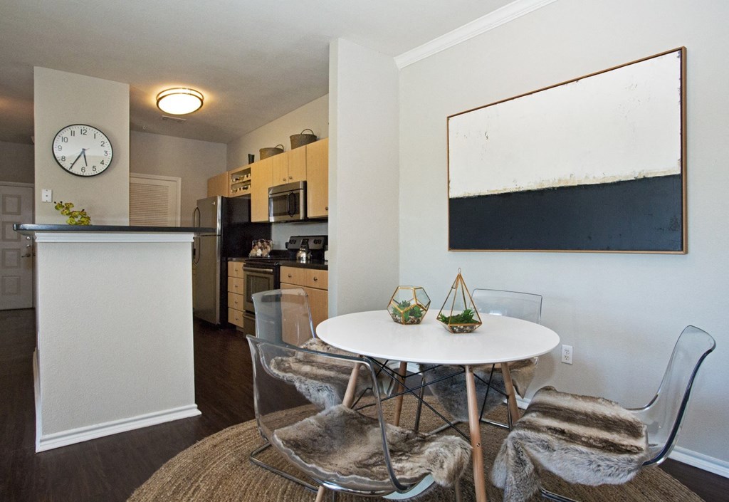 a dining room with a table and chairs and a kitchen