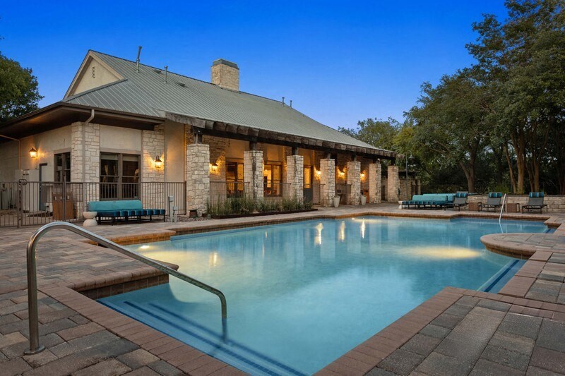 a swimming pool with a stone building in the background