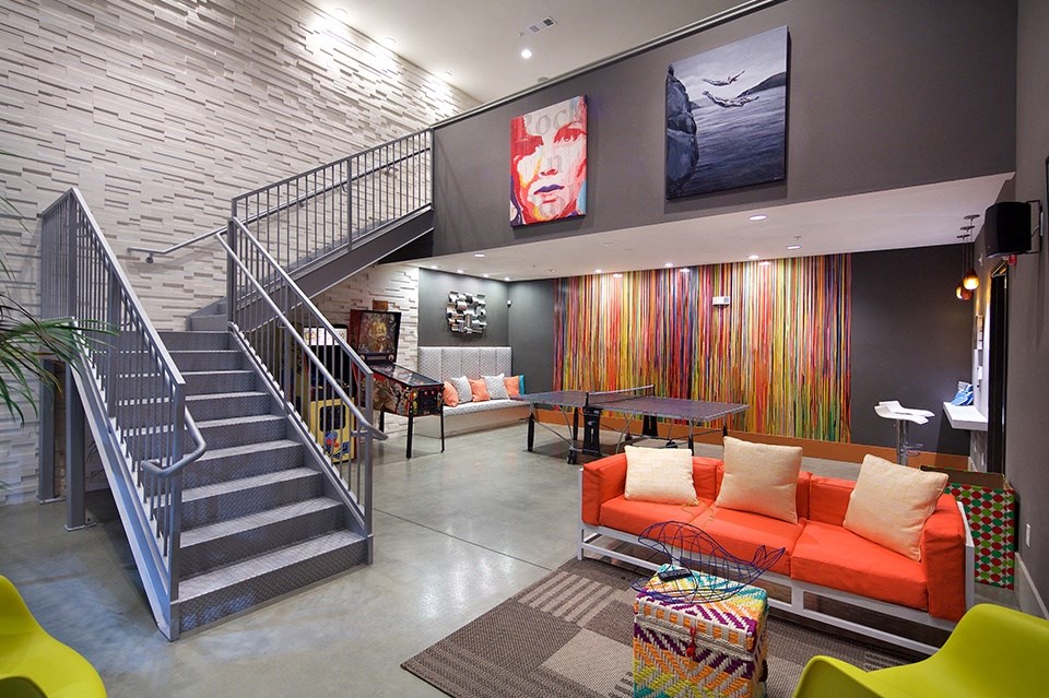 A living room with a staircase and a couch.