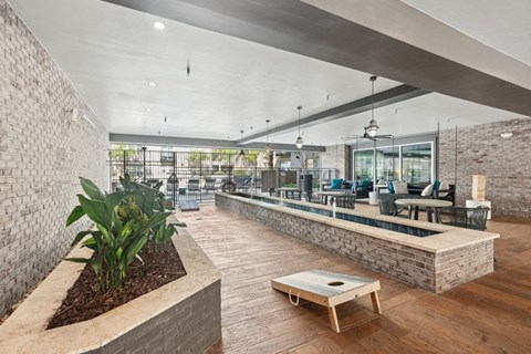 the lobby of a building with a reception desk and a seating area