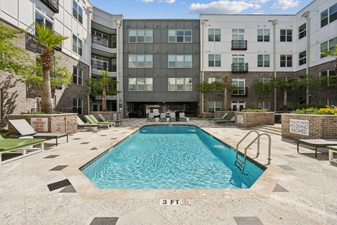 A pool in front of a building with a sign that says 3 feet.