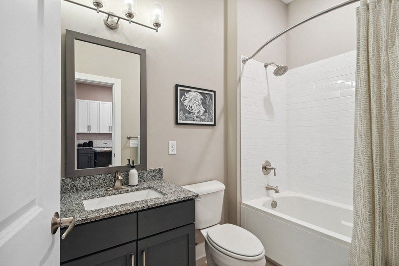 a bathroom with a shower toilet and sink and a mirror