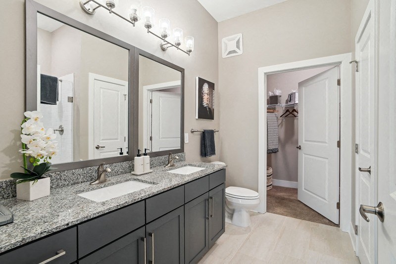 a bathroom with two sinks and a toilet