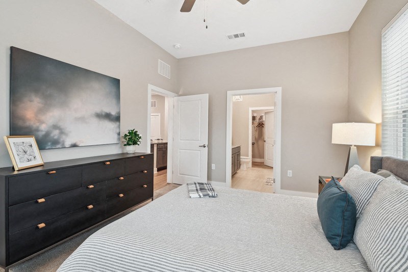 a master bedroom with a large bed and a tv