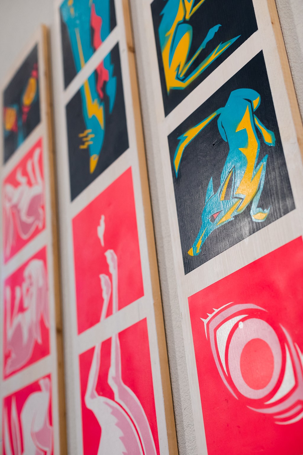 a row of framed illustrations hanging on a wall