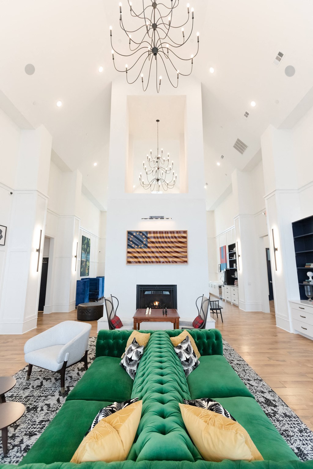 a living room with a large green couch and a fireplace