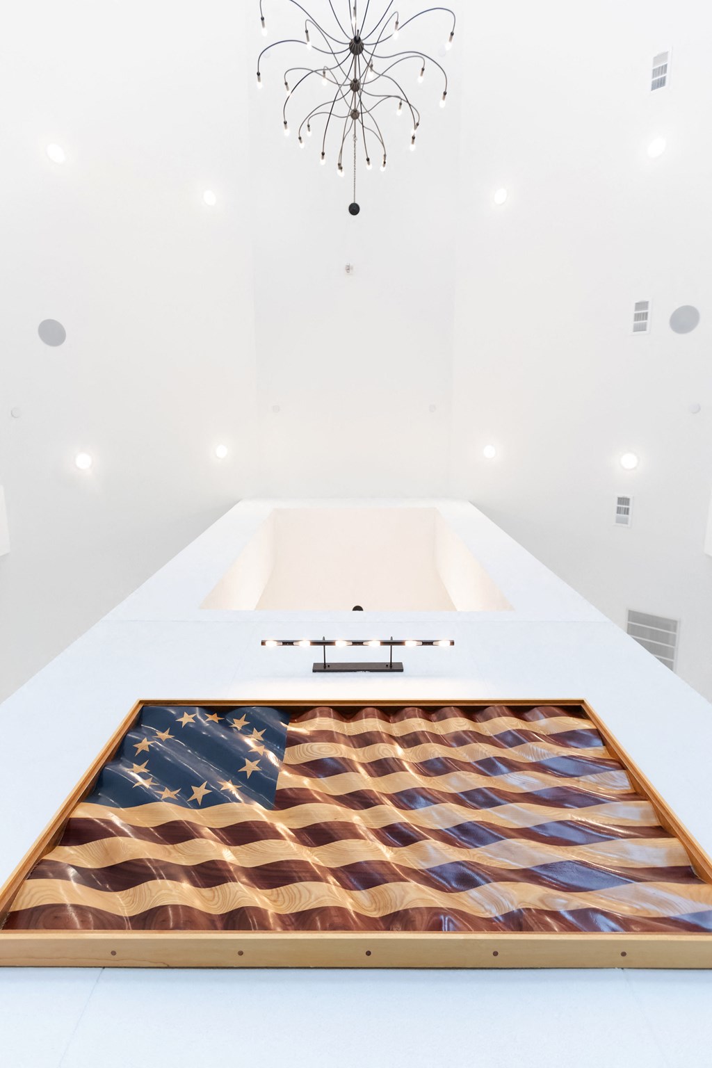 a bathroom with a bathtub and a rug with a flag on it