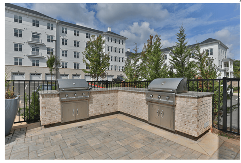 the patio has two bbq grills and a built in grill