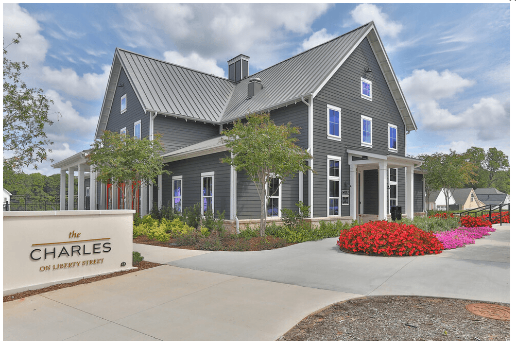 a home with a gray exterior and a metal roof