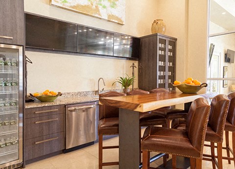 a kitchen with a table and chairs and a refrigerator
