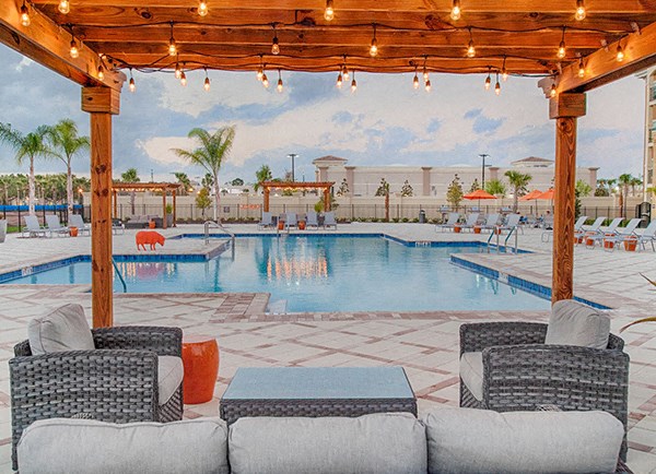 Photo of outdoor patio and pool with chairs