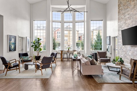 a clubhouse with large windows and furniture