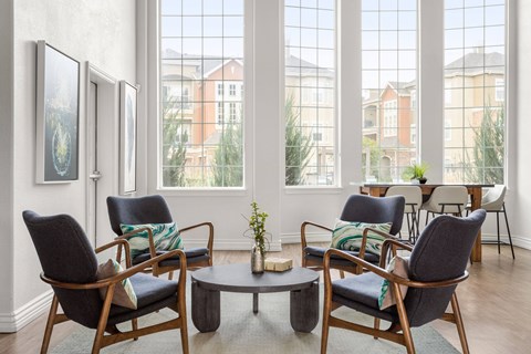 a clubhouse with chairs and a table and windows